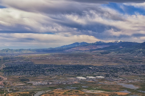 Great Salt Lake Utah Aerial view from airplane looking toward Oquirrh Mountains and Antelope Island, Tooele, Magna, with sweeping cloudscape. United States.