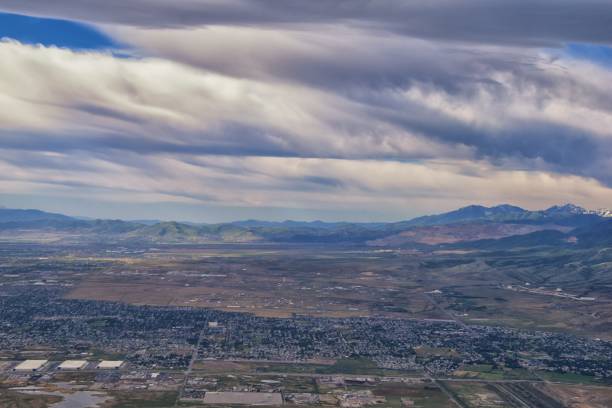 Great Salt Lake Utah Aerial view from airplane looking toward Oquirrh Mountains and Antelope Island, Tooele, Magna, with sweeping cloudscape. United States. Great Salt Lake Utah Aerial view from airplane looking toward Oquirrh Mountains and Antelope Island, Tooele, Magna, with sweeping cloudscape. United States. tooele stock pictures, royalty-free photos & images