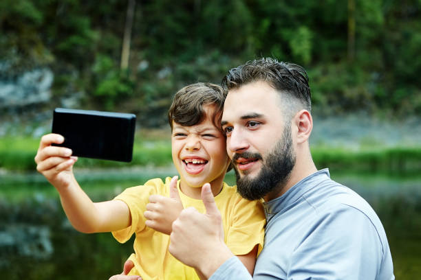 istock Father and son take selfies in nature. 1171538155