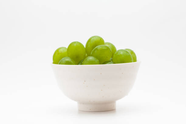Green grapes in a bowl isolated