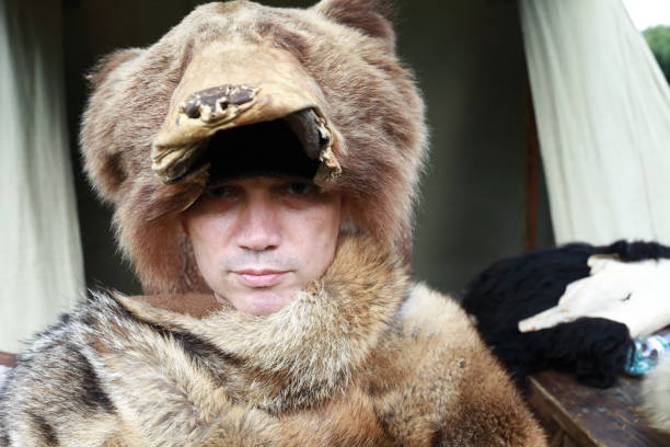 istock Serious man in fur cape and hat 1171544920