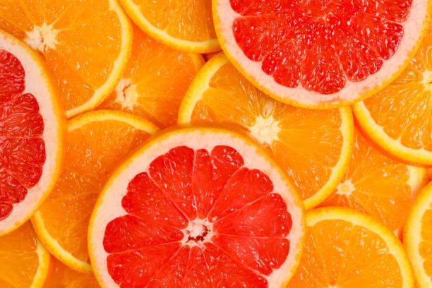 istock Slices of oranges and a grapefruits as a background. 1171545903