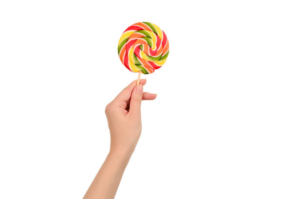 istock Lollipop in female hand isolated on white  background. Space for text or design. 1171545913
