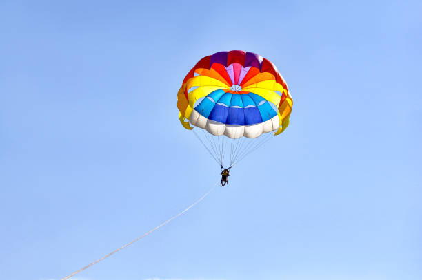 istock Para sailing using a parachute on background of blue sky. 1171546145