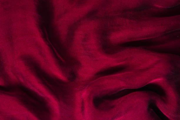 istock Soft smooth burgundy silk fabric background. Fabric texture. 1171546201