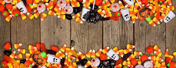 istock Halloween candy double border banner on a rustic wood background with copy space 1171546989