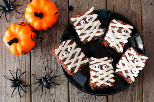 istock Halloween mummy brownies, above view with decor over wood 1171548070