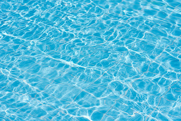istock Background of water in blue swimming pool, water surface with a sun reflection 1171548214