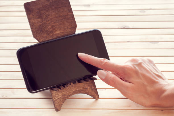 istock mobile phone and a female hand 1171549661