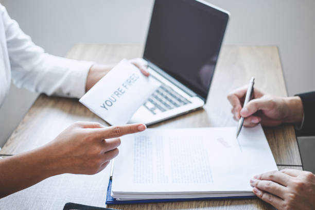 istock Stressed businessman receive fired letter from employer will be signing approve contract agreement, changing and resigning from work concept 1171554728