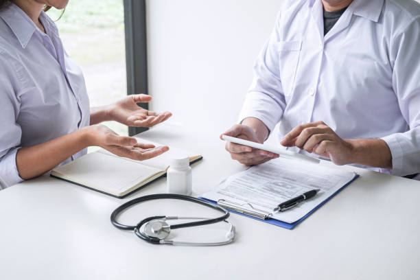 istock Doctor consulting with patient and checking sickness condition while presenting results diagnosis symptom examining about the problem of illness and recommend treatment method, Healthcare and medical 1171554758