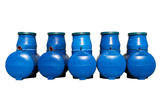 istock Blue plastic septic tanks are standing. Five cylindrical containers in a row. Isolated white background, a large barrel of sewage. 1171558952
