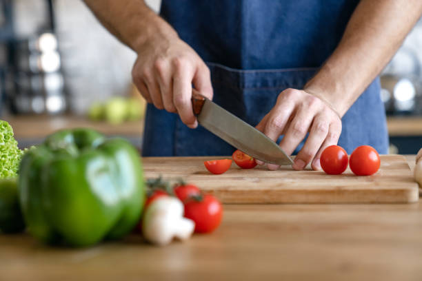 istock Cropped shot of man cooking on kitchen with vegetables on table 1171560064