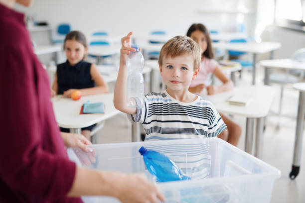 istock A teacher with small school kids in classroom learning about waste separation. 1171560875