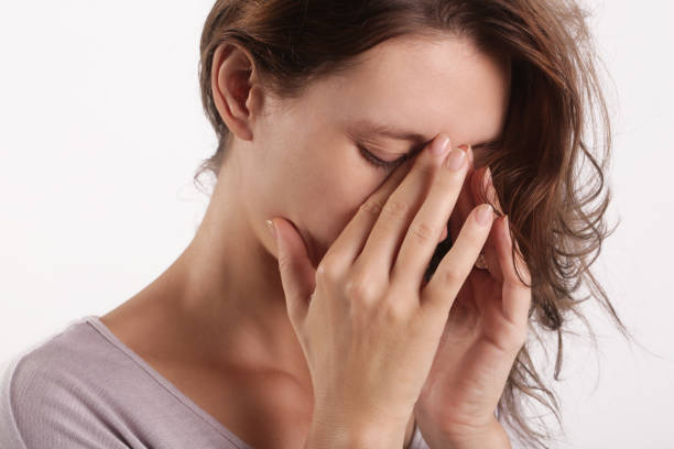 Studio shot of a young woman suffering from symptoms of sinus Infection (Sinusitis) stock photo
