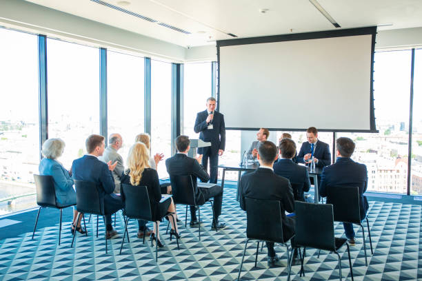 istock Speaker and audience at conference 1171568972
