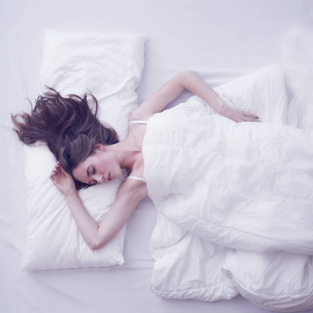 istock Young woman sleeping in bed 1171568975