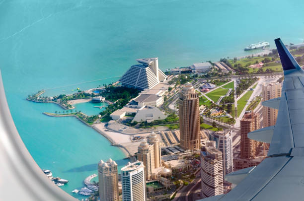 istock Plane flies over the coast of Doha. 1171570401