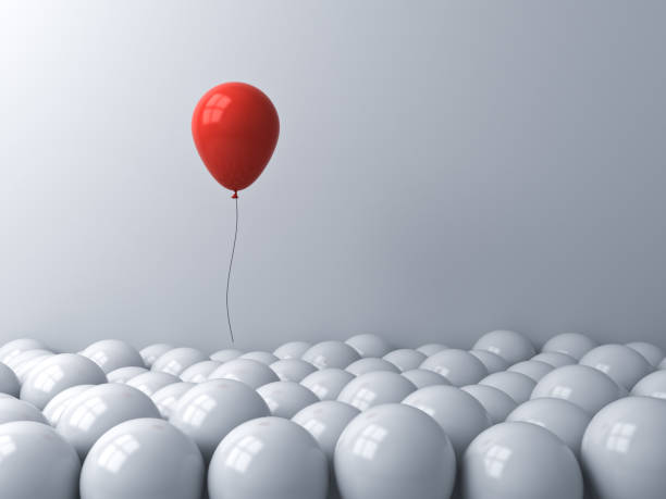 istock Stand out from the crowd and different or think outside the box creative idea concepts One red balloon floating above other white balloons on white background with window reflections 1171571425