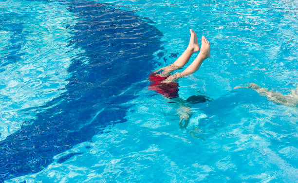 istock Diving in pool. Happy little boy spending time in pool 1171572955