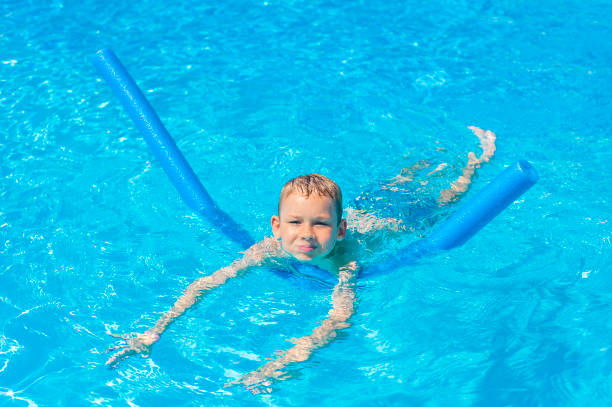 istock Boy at swimming pool class learning to swim