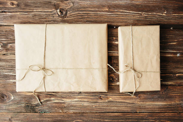 istock Two gift boxes wrapped in kraft paper on wooden table 1171579469
