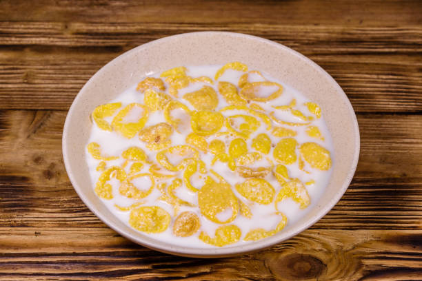 istock Ceramic plate with cornflakes and milk on a wooden table. Healthy eating 1171580123