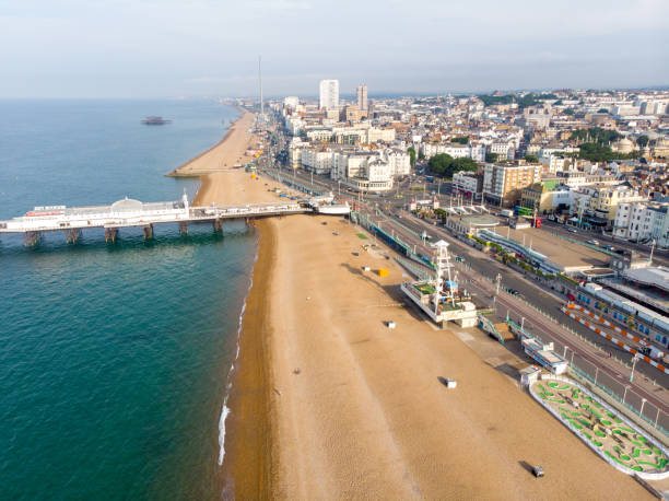 Aerial photo of the famous Brighton Pier and ocean located in the south coast of England UK that is part of the City of Brighton and Hove, taken on a bright sunny day showing the fairground rides. stock photo