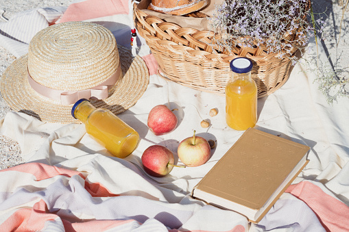 Summer - picnic by the sea. basket for a picnic with with buns, apples and juice