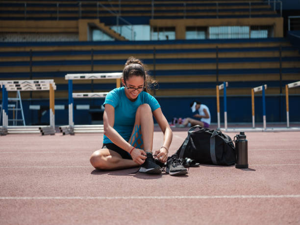 College athlete tying running shoes