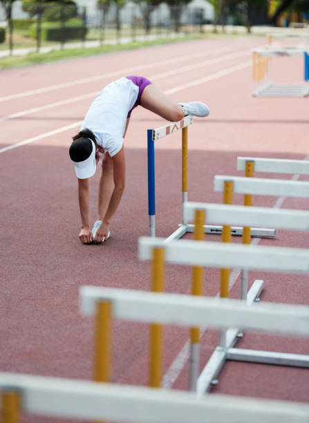 istock Female runner stretching on campus track 1171582697