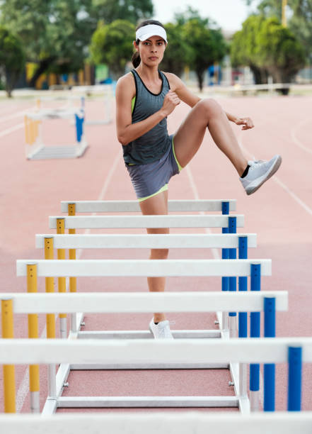 istock Female athlete practicing with hurdlers 1171582723