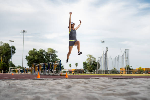 istock Female long jump runner in mid-air 1171582725