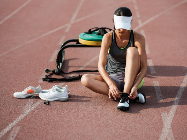 istock Latin athlete tying sports shoe 1171582737