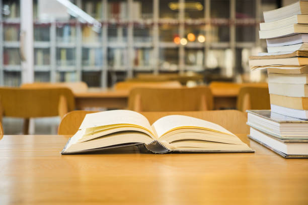 istock Old textbook are open placed on a wooden table 1171583931