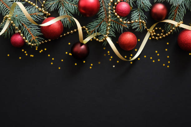 istock Christmas dark black background with red baubles, Christmas decorations, fir tree branches, confetti star. Xmas frame border, top view, copy space. Greeting card mockup. 1171586232