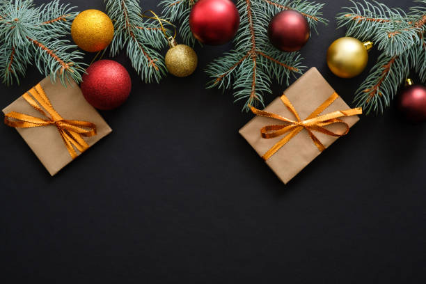 istock Christmas frame border with golden and red decorations, gift boxes, baubles on dark black background. Flat lay, top view, copy space. Christmas holidays, New Year greeting card mockup 1171586233