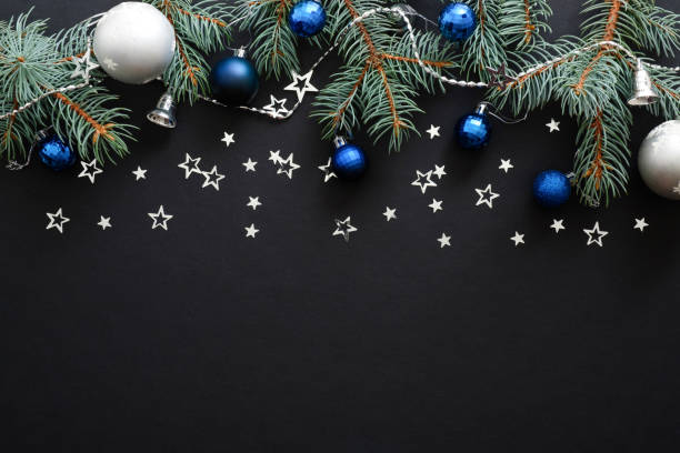 istock Christmas composition with blue and sliver modern decorations, baubles, fir tree branches on dark black background. Elegant Christmas banner mockup, greeting card template. Xmas, New Year concept. 1171586241