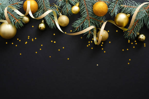 Black Christmas background with golden decorations, baubles, fir tree branches, confetti. Christmas holiday celebration, winter, New Year concept. Christmas banner mockup, greeting card template.
