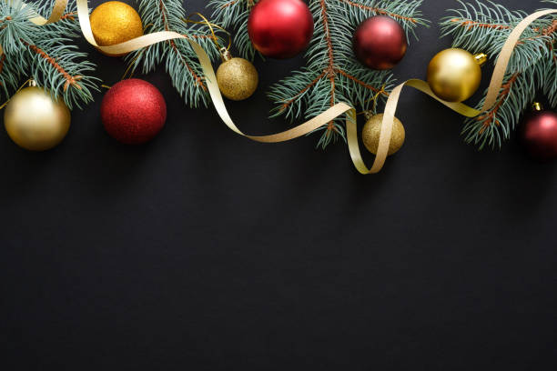 istock Black Christmas background with golden and red decorations, baubles, fir tree branches. Christmas holiday celebration, winter, New Year concept. Christmas banner mockup, greeting card template. 1171586277