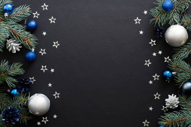 istock Christmas frame border with blue and sliver modern decorations, baubles, fir tree branches, confetti on dark black background. Elegant Christmas banner mockup, greeting card template 1171586283