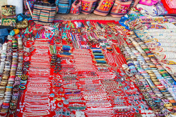 Local market shopping in India Indian jewellery and fabric at the local market in India india indian culture market clothing stock pictures, royalty-free photos & images