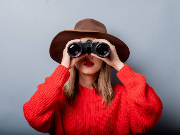 istock woman in red sweater and hat with binocular 1171587463