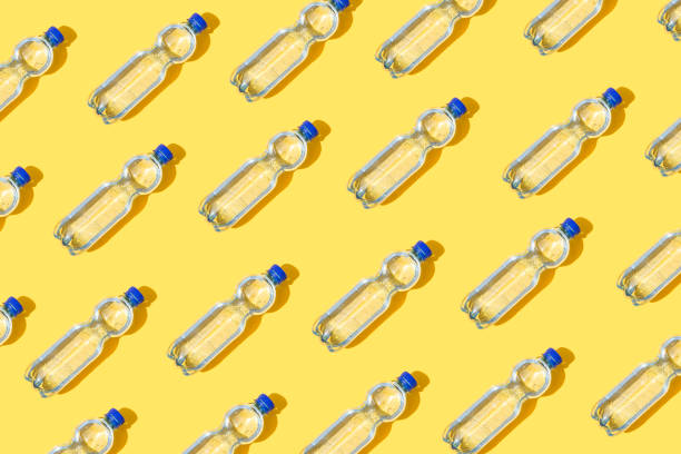 Mineral water Mineral water bottles on yellow background purified water photos stock pictures, royalty-free photos & images