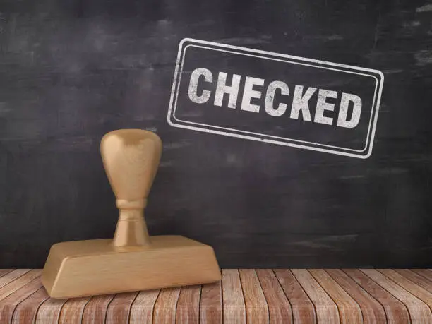 Photo of CHECKED Rubber Stamp on Chalkboard Background - 3D Rendering