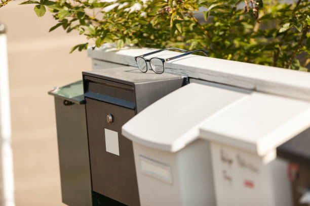 istock White and green mailboxes on a wooden white fence 1171590463