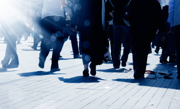 istock crowded people walking on busy street 1171590920