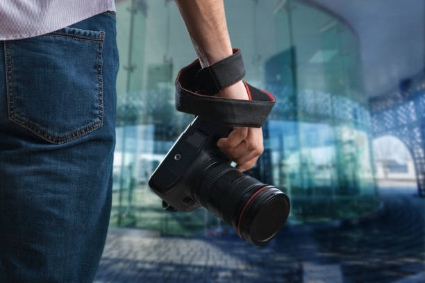 istock Young man holds black modern digital camera 1171592198