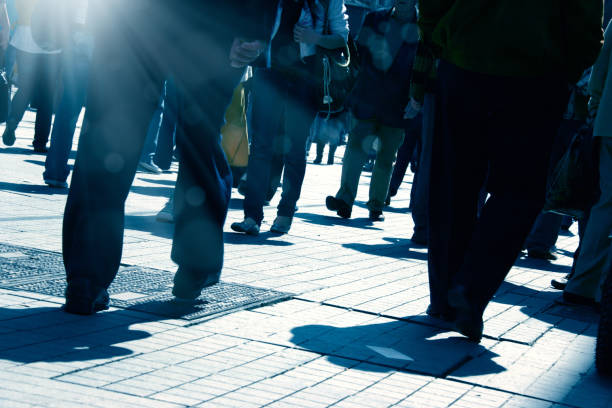 istock crowded people walking on busy street 1171592431