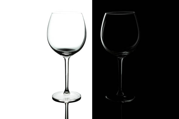 istock Clean Empty wine glasses with reflections on black and white background. Alcohol beverage card backdrop. 1171594422